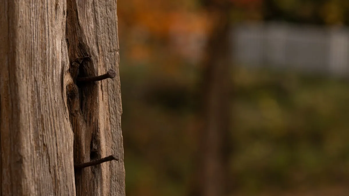 Fence repair crew resetting a leaning wood fence post in Edina, MN