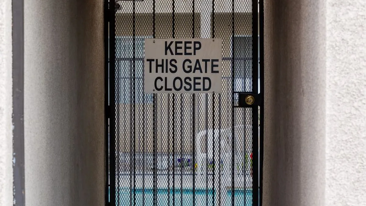 Aluminum pool fence with self-closing gate around a backyard pool in Edina, MN